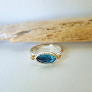 Rose Cut Blue Topaz ring on driftwood