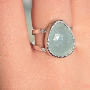 Aquamarine ring on woman's finger